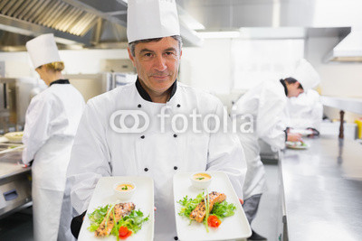 Chef_holding_out_two_salmon_dishes_2.jpg