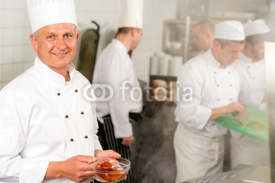 Professional_kitchen_smiling_chef_add_spice_food_2.jpg